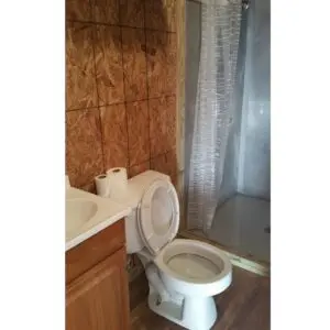A Toilet With Shower and Sink.